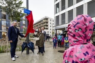 Le syndic Grégoire Junod et les municipaux Natacha Litzistorf et David Payot ont devoilé la plaque de la Place Buissonnière aux Plaines-du-Loup. KEYSTONE/JEAN-CHRISTOPHE BOTT
